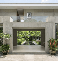 Wide open concrete entrance leading into a villa